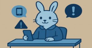 相談センターの机に座るウサギキャラがスマホを見ながら注意喚起する青系フラットデジタルアート