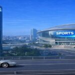 丸型高層ビルとスポーツホールが並ぶ都市風景のイメージ